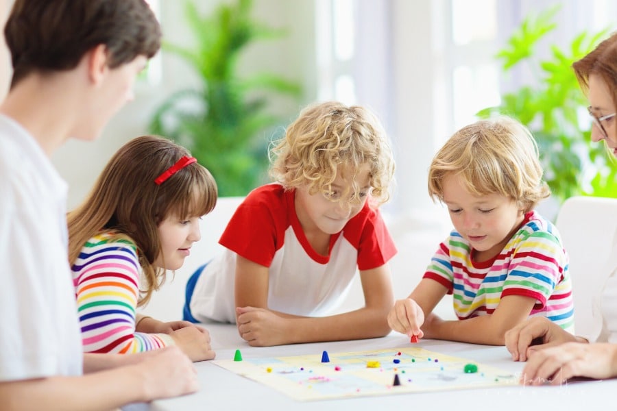 family playing strategic board games with kids
