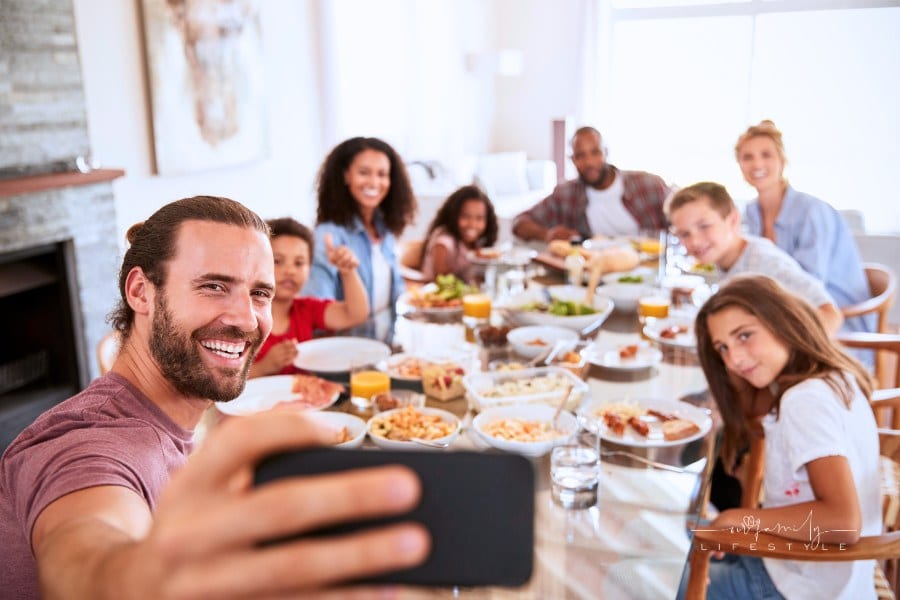 Two Families Taking Selfie while enjoying lunch together in vacation rental house