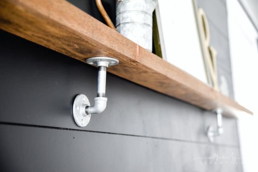 wood shelf with plumbing pipes