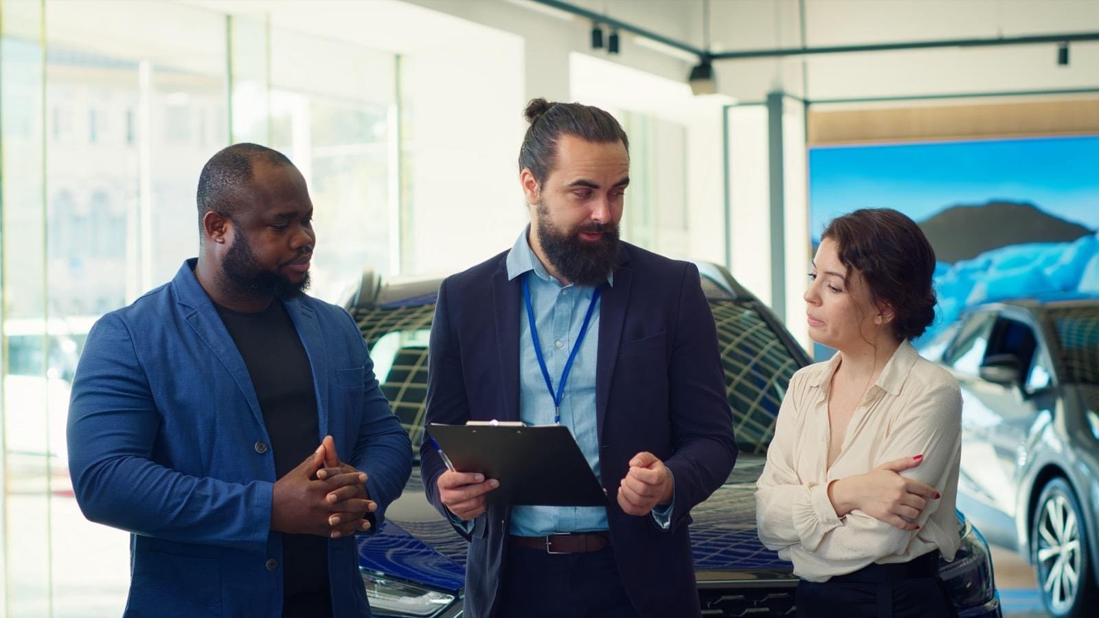 used-car-age-loan-term.jpg Dealership salesperson explaining vehicle and finance options to buyers