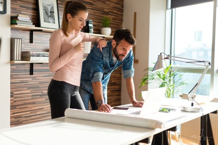 couple working together on laptop at their family business