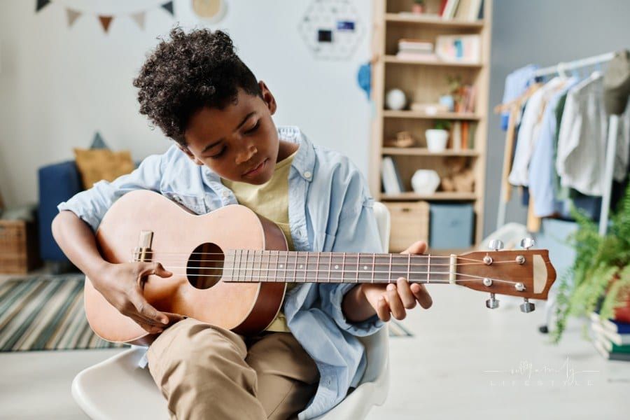 Boy Learning to Play Guitar