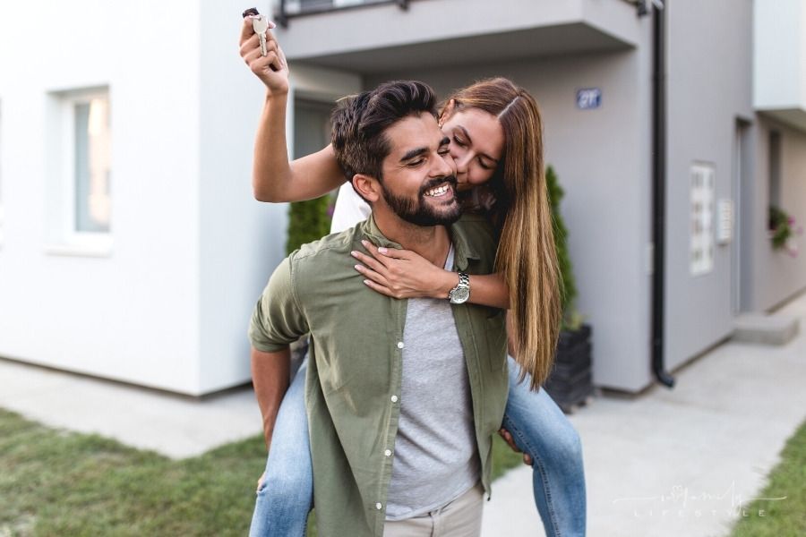 couple celebrating with keys to new house