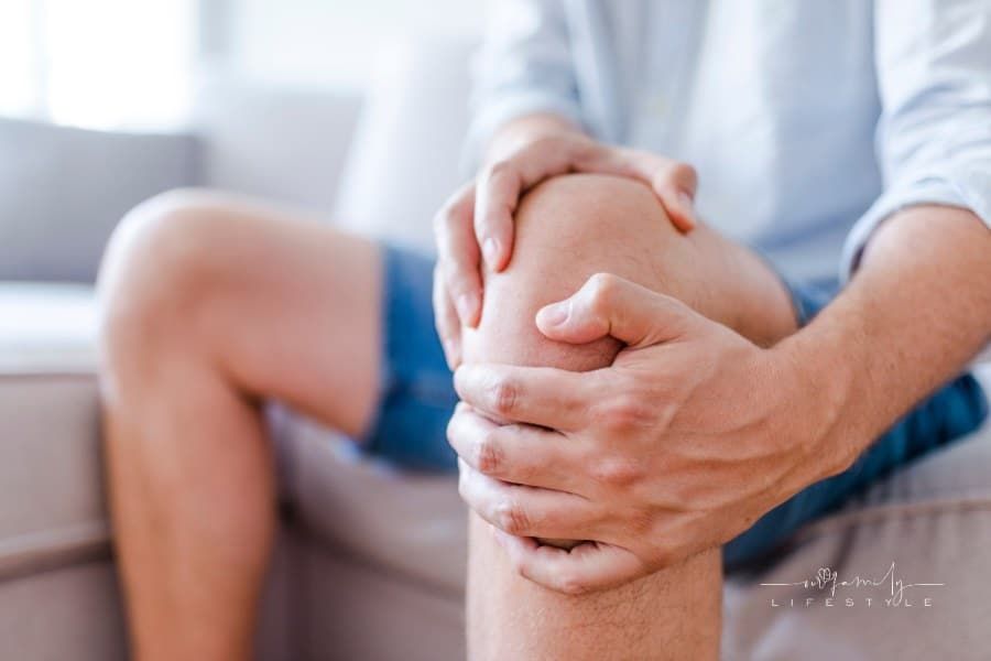 man holding knee due to joint pain