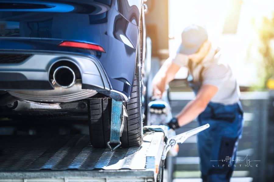 Man securing car before shipping