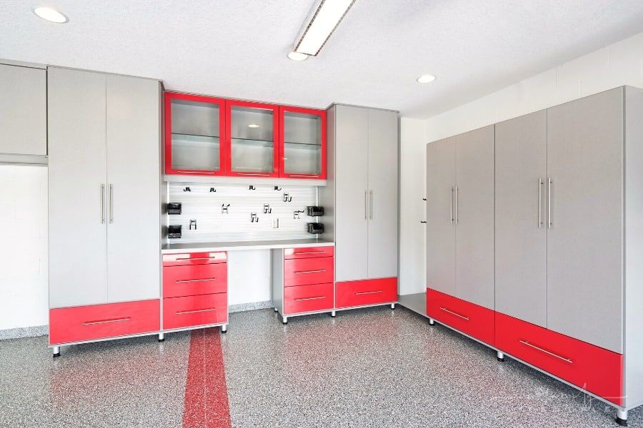 bold colored storage cabinets, organization tracks, and flooring in garage space
