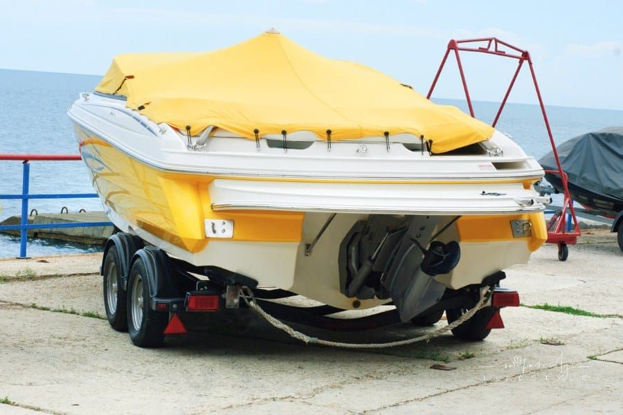 Yellow Covered Boat on a Trailer