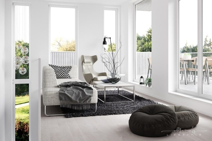 modern living space with black rug and grey furniture