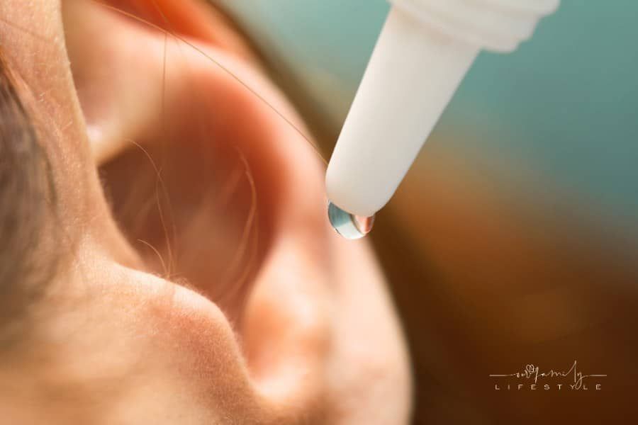 Woman Applying Medical Ear Drops