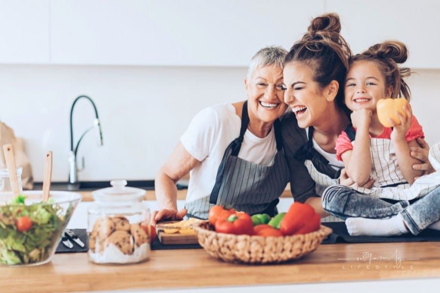 Three generations women laughing in the kitchen