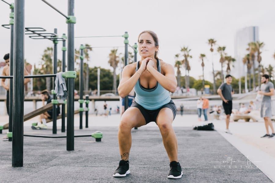 Woman Doing Squats in a Public Park for Fitness