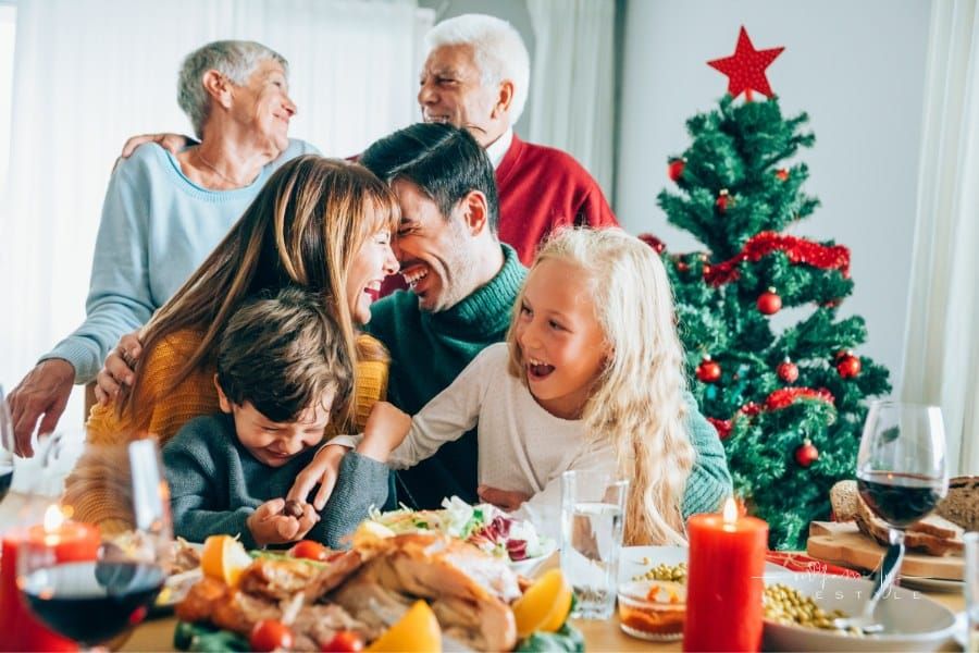 Three generation family laughing during christmas portrait.