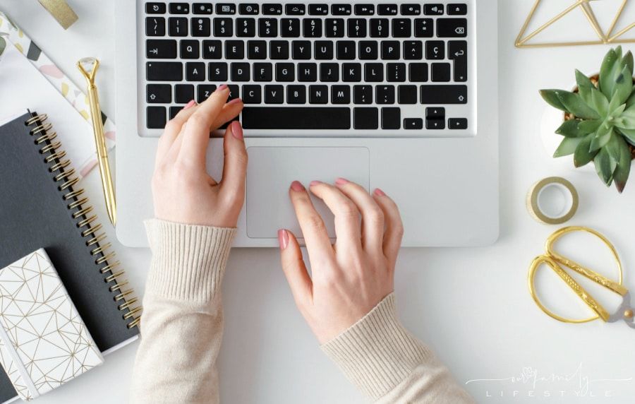 female entrepreneur typing on laptop