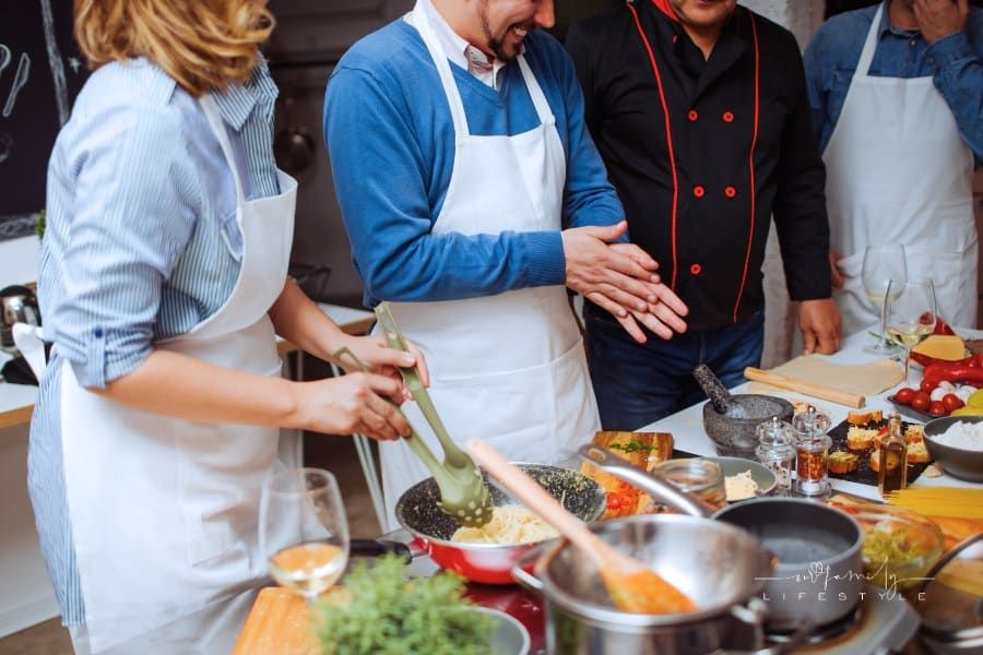 Chef teaching couple in a cooking class