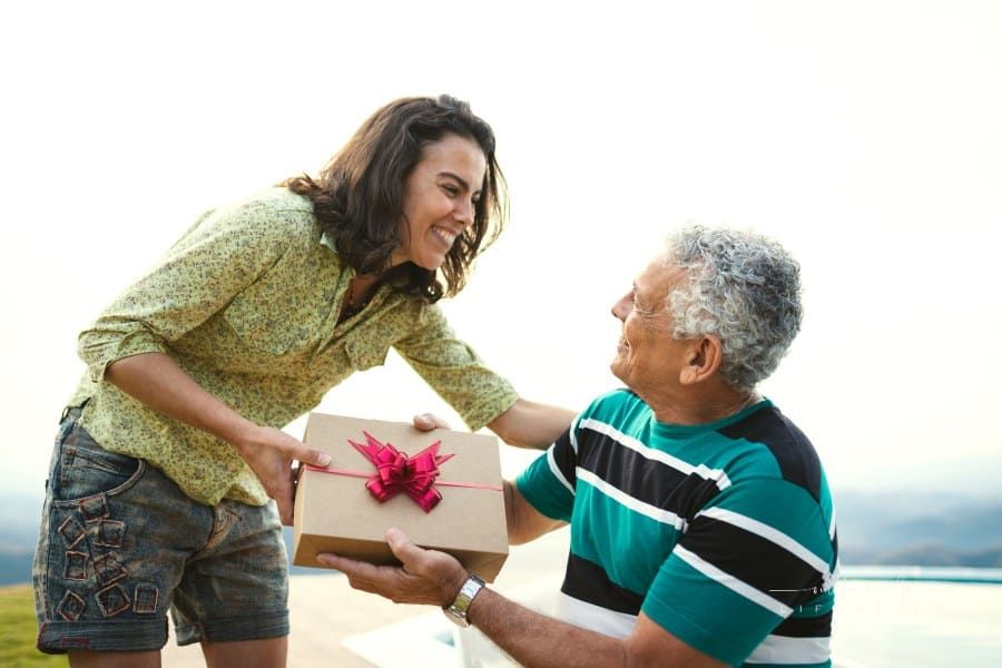 Daughter giving a gift for her dad.