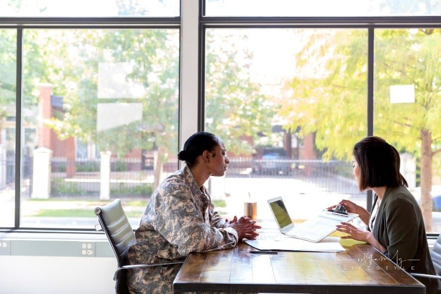 Loan officer reviews loan application with female veteran