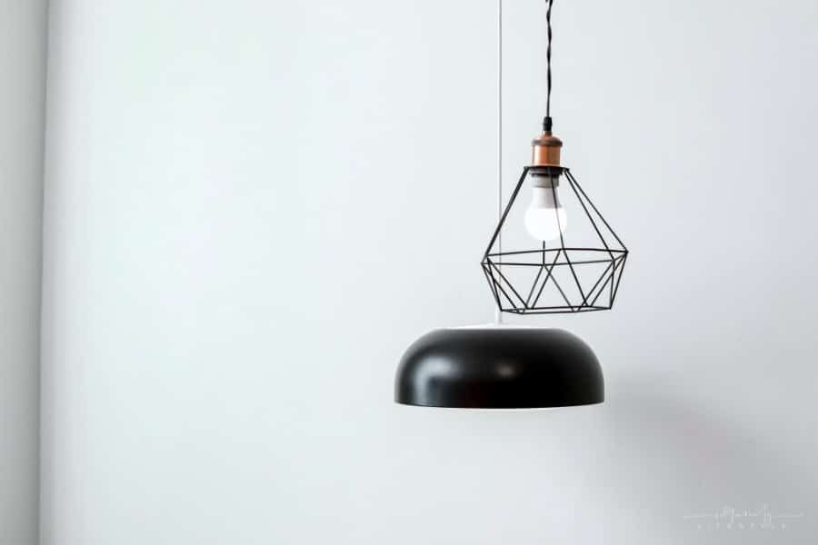 stylish pendant lamps hanging in front of gray wall