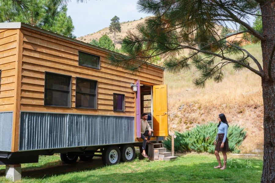 Young couple outside their tiny house