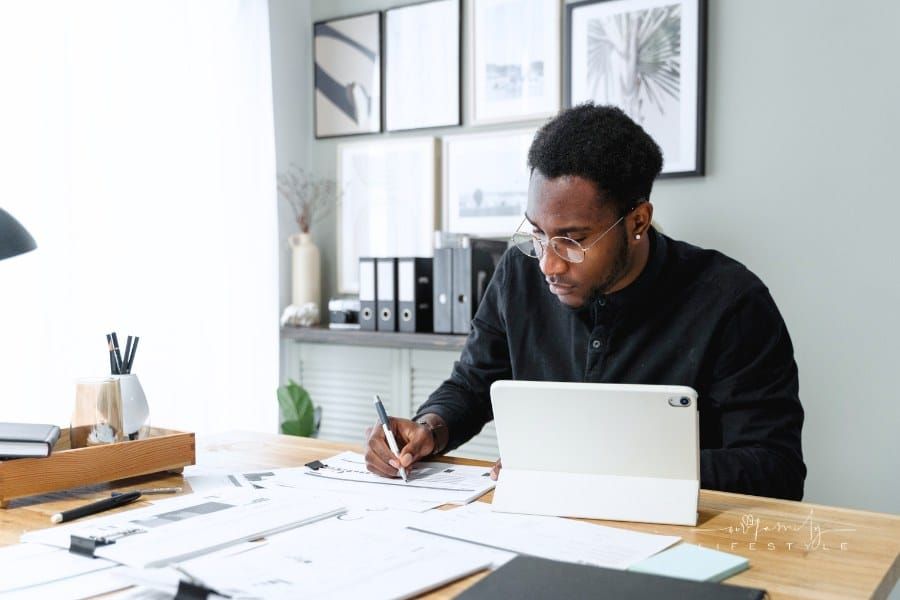An Accountant Writing on White Paper