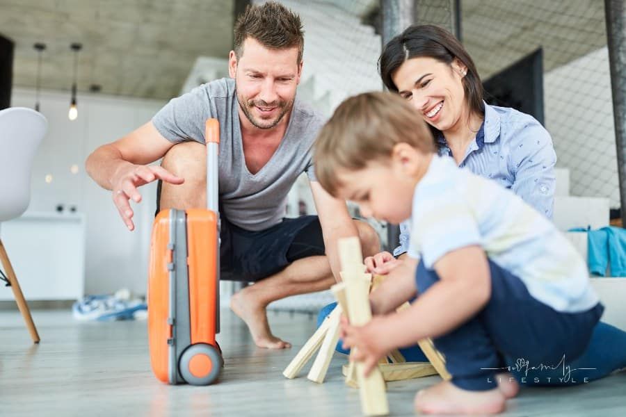 Parents and toddler play making fire and survival training in the living room