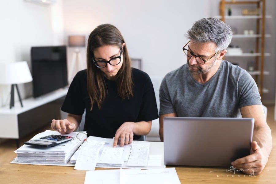 couple looking over receipts while working on family budget