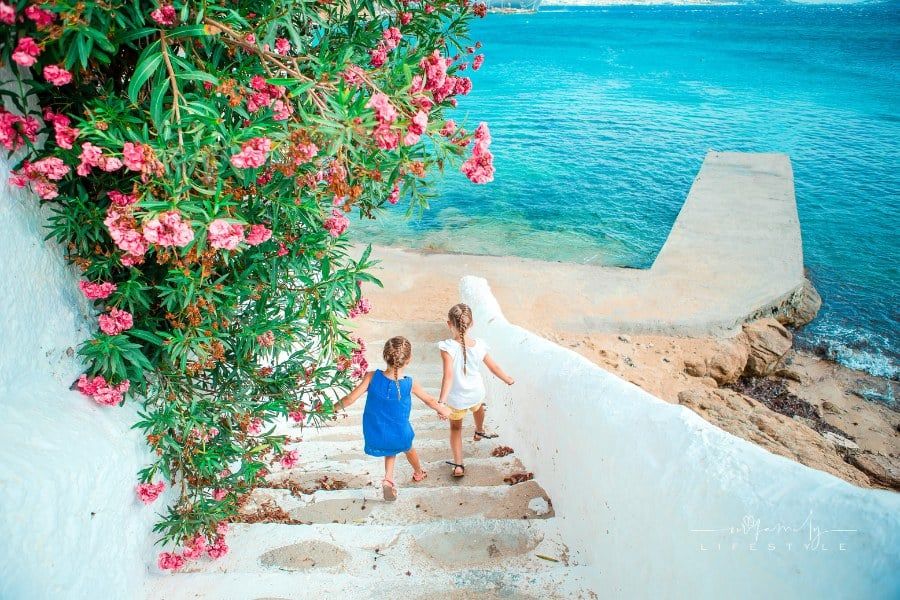 Kids having fun outdoors on Mykonos background of the sea