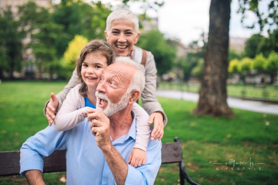 grandparents at the park with a grandchild