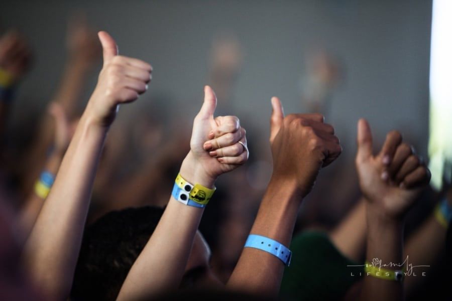 group of people giving a thumbs up while wearing silicone wristband