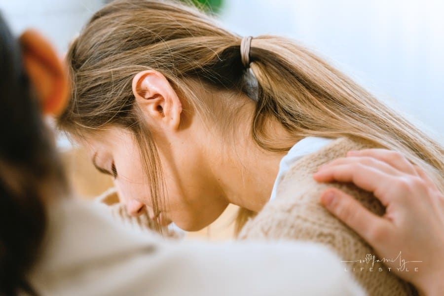 Woman Crying with a Hand on Her Shoulder