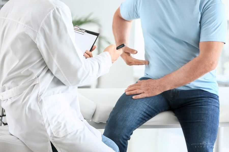male patient explaining side pain to a male doctor