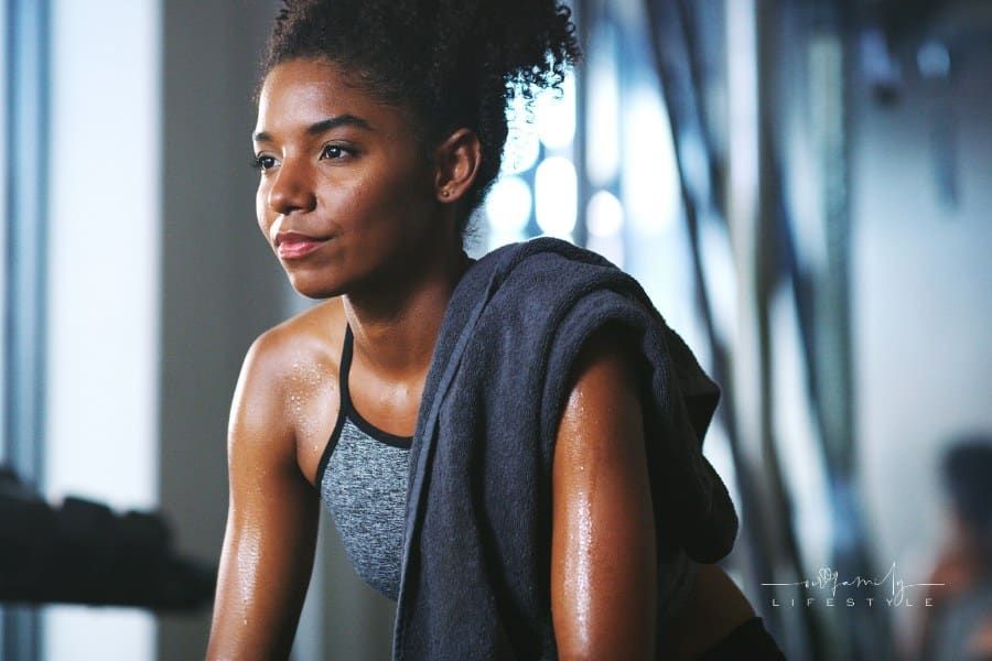 Shot of a sporty young woman taking a break while exercising at the gym