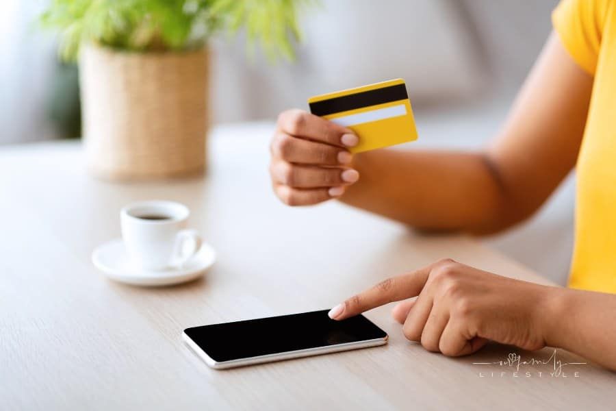 woman using smartphone and credit card