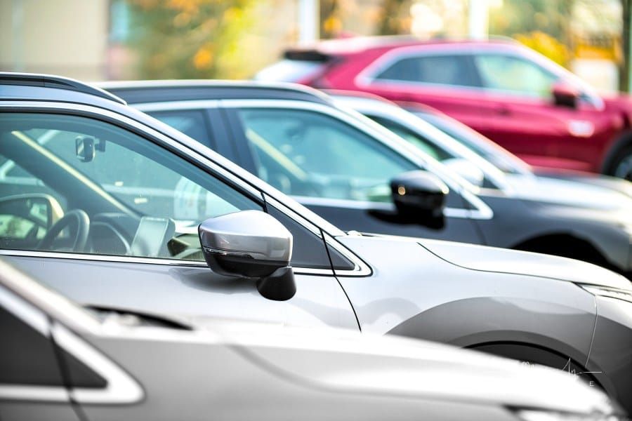 side shot of used cars lined up at auto dealership