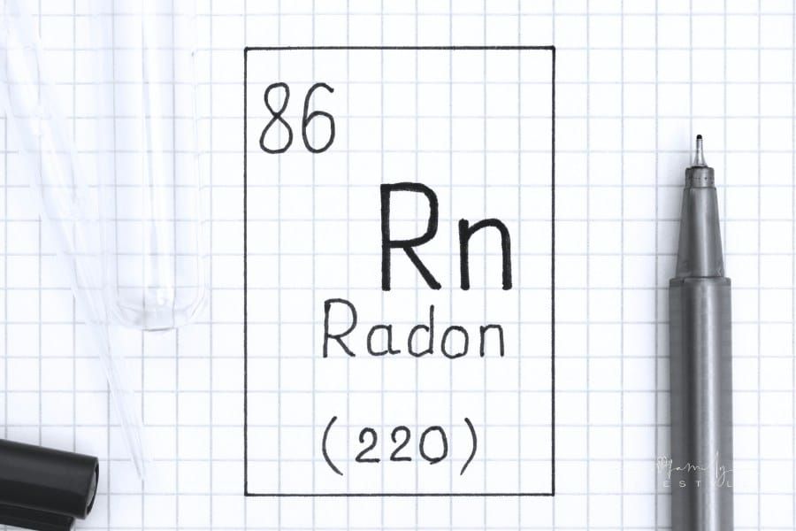 The Periodic table of elements. Handwriting chemical element Radon Rn with black pen, test tube and pipette.