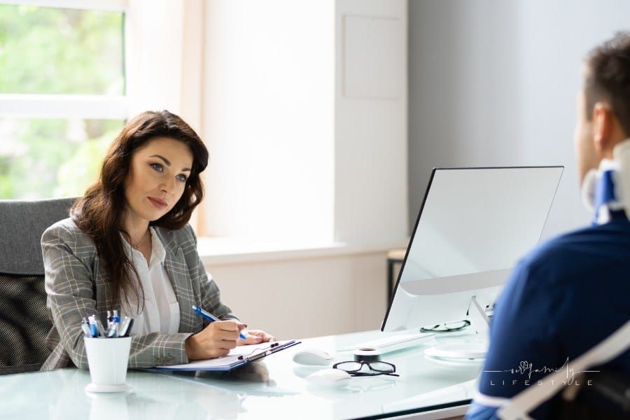 Professional female personal injury lawyer discussing legal case with client meeting with document contract in office