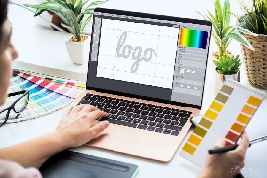 graphic designer working on a logo on a laptop