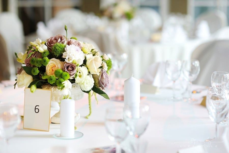 table set for reception with flowers, candles and table number