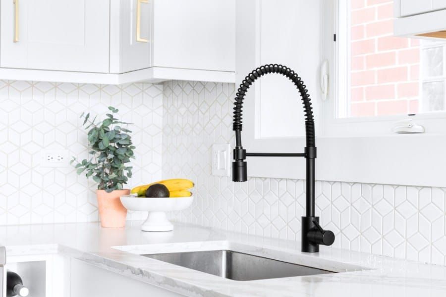 A white kitchen sink detail shot.