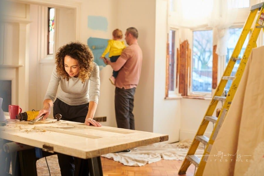 young couple with toddler working on home renovatin project