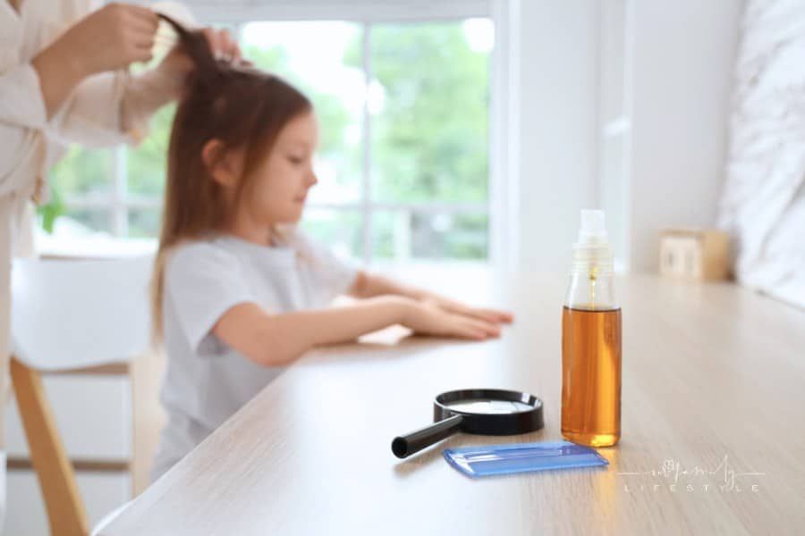 Head Lice Comb with Magnifier and Treatment for Lice on Table in Room, Closeup