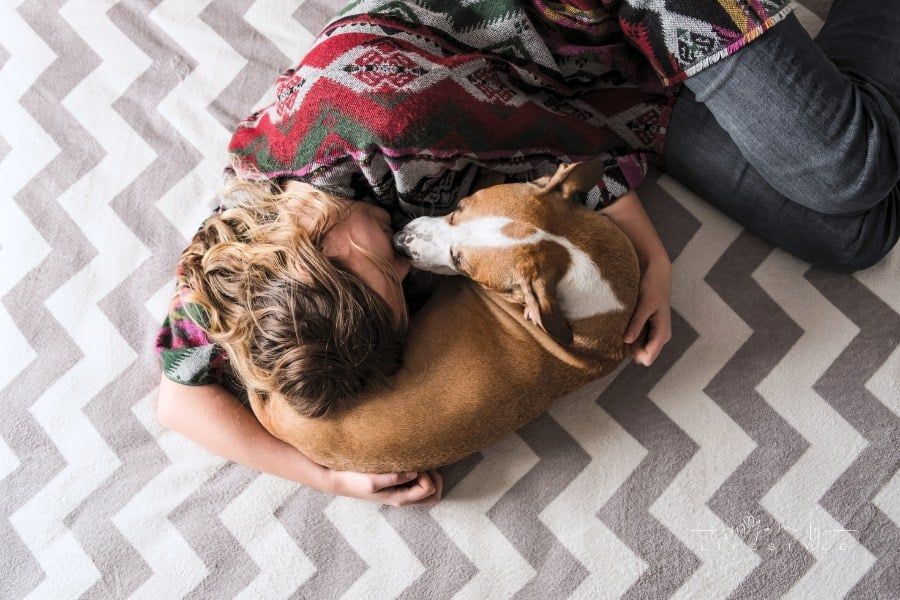 Woman Laying Down with Pet Dog