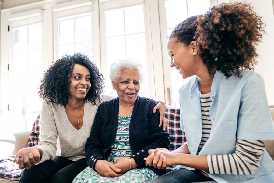 caregiver of senior parent talking to assisted living care provider