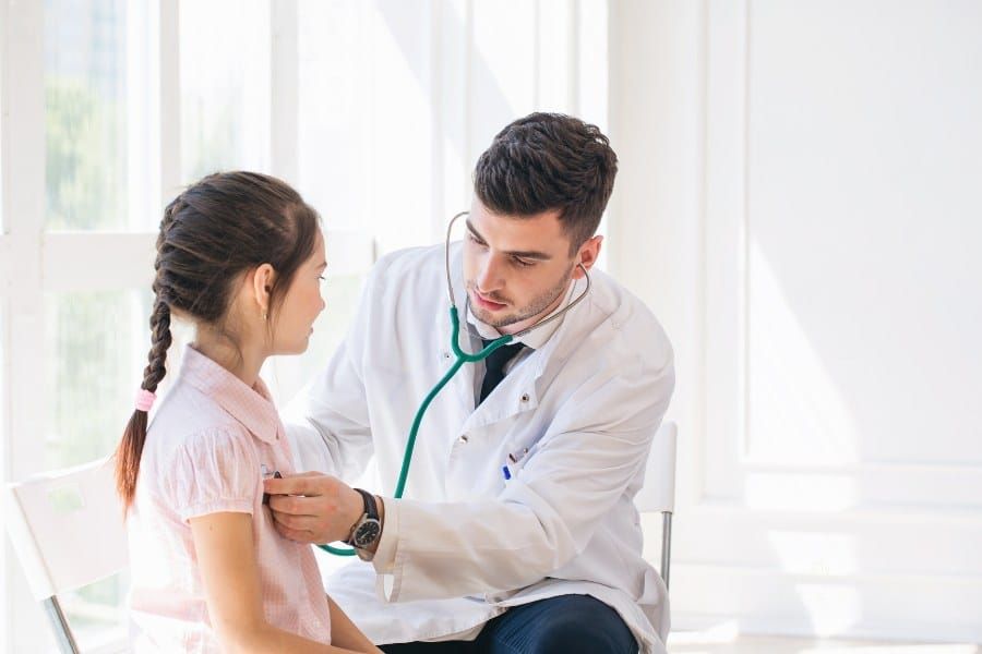 Pediatrician doctor examining child