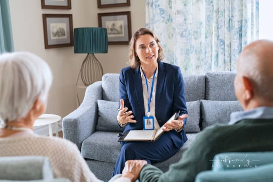 Social Worker Talking to Senior Couple at Home