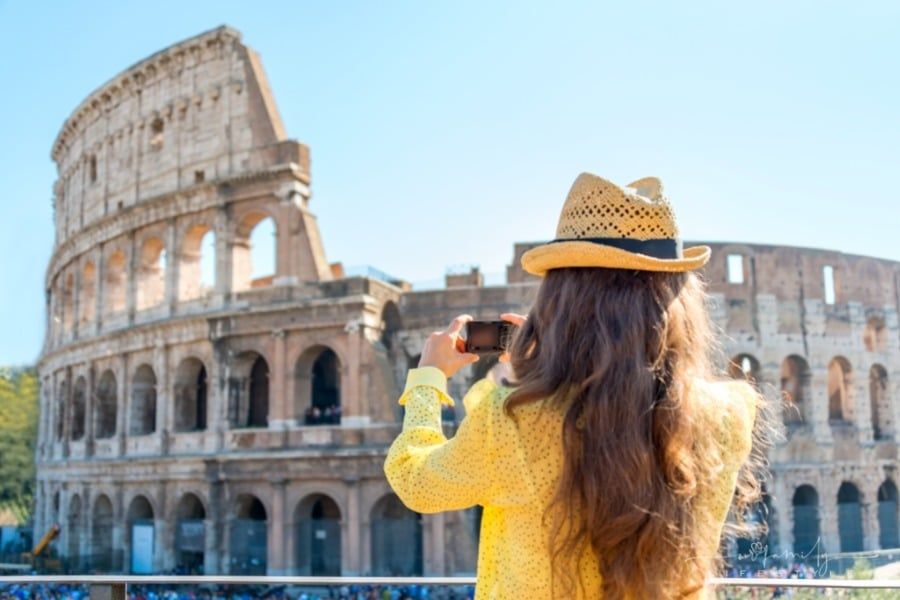 tourist taking picture of Colosseum in Rome, Italy