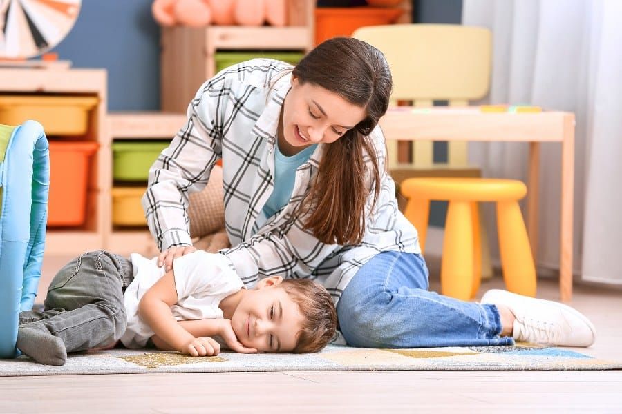 Nanny and Little Boy Playing at Home