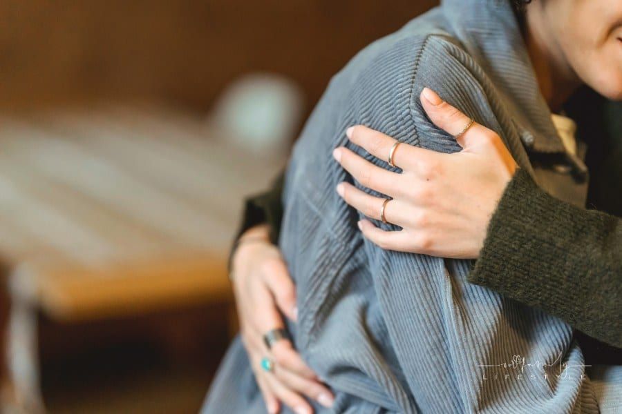 Woman comforting depressed loving one and embracing gently