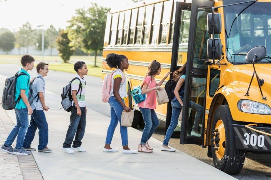 Middle school students boarding a bus