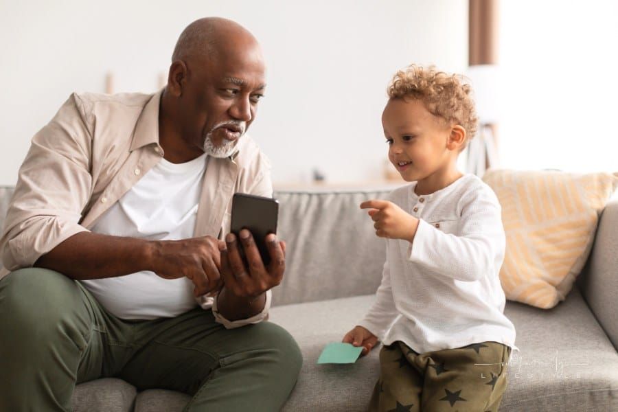 Grandpa Showing Smartphone to Grandson at Home