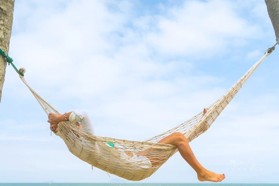 woman relaxing at the beach in a hammock